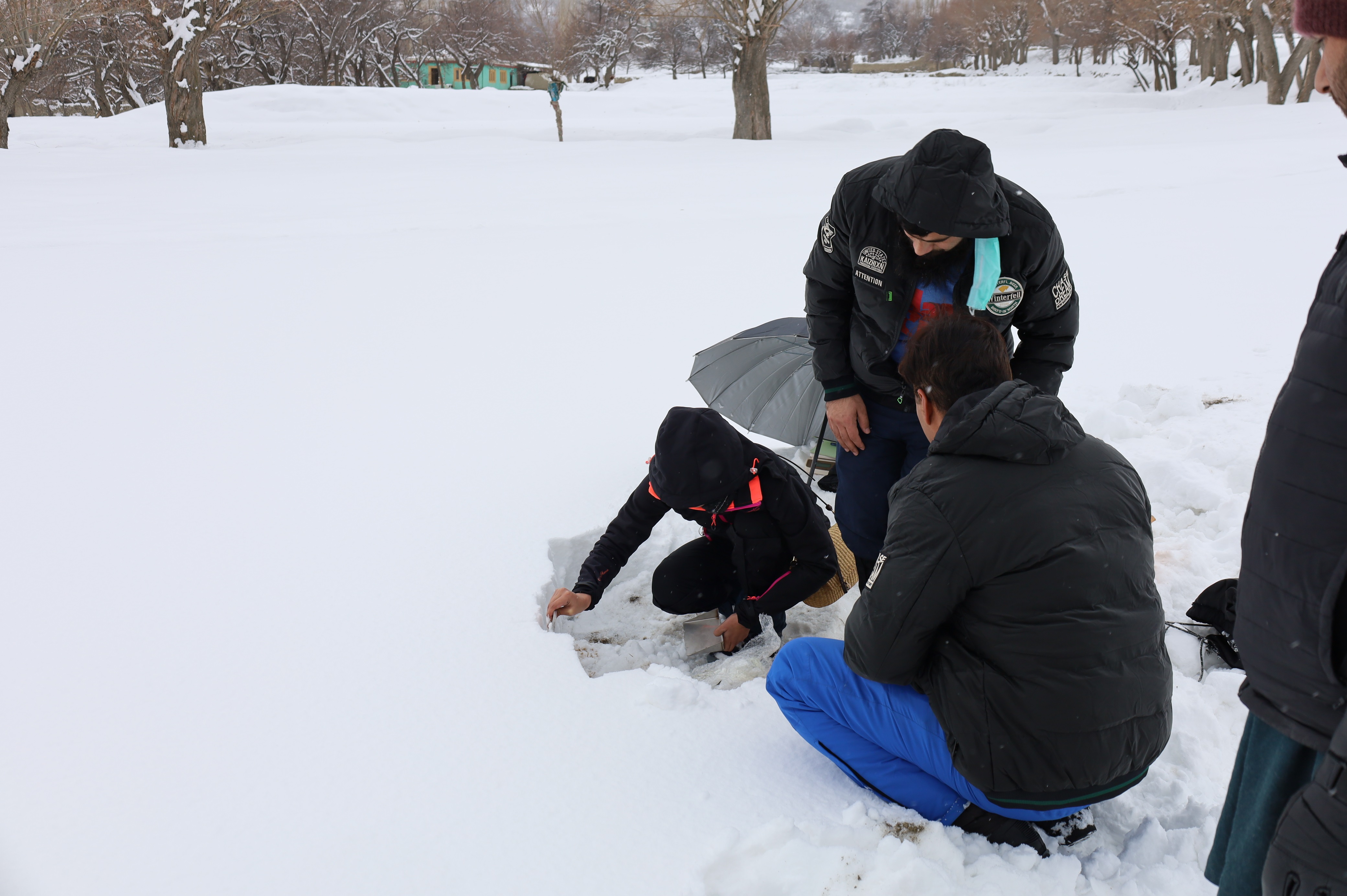 WIT team collecting snow samples, closer view